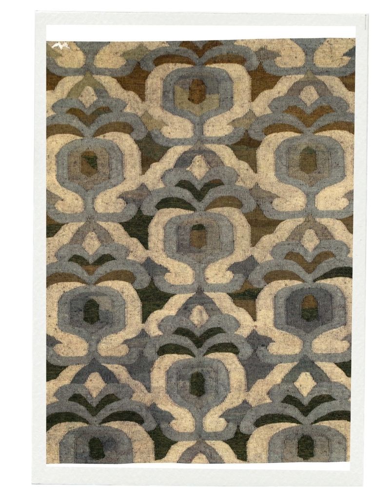 Handwoven dhoku rug with structured geometric pattern in muted green and beige tones